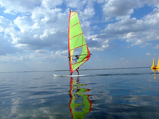 Image showing Windsurfer and its reflection in water of a gulf 2