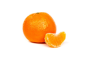 Image showing Ripe tangerine or mandarin with slices on white