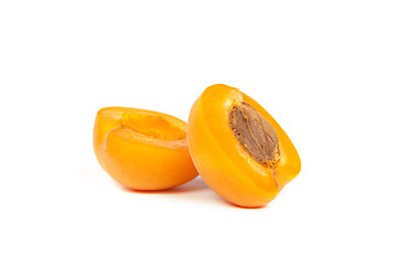 Image showing Two ripe apricot sectioned by knife