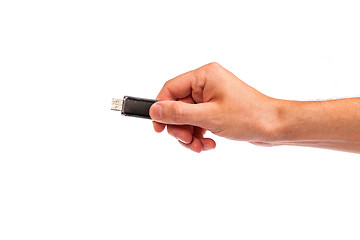 Image showing Closeup image: hand holding black USB data storage or connecting