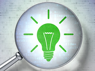 Image showing Business concept:  Light Bulb with optical glass on digital back