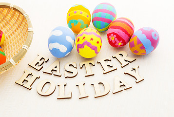 Image showing Painted easter egg in basket with wooden text