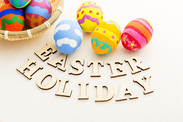 Image showing Colourful easter egg with wooden text 