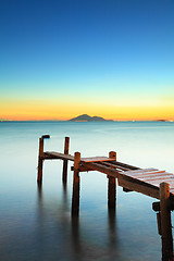 Image showing Seascape with sunset and wooden bridge