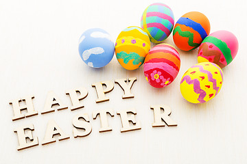 Image showing Colourful easter egg and wooden letter