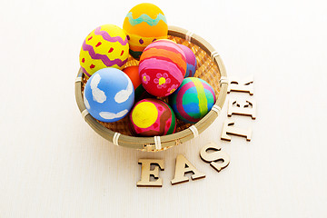 Image showing Easter egg in basket with wooden text