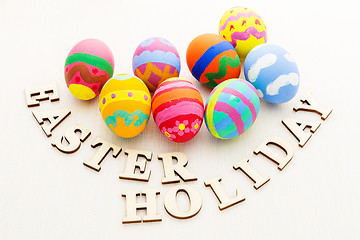 Image showing Colourful easter egg with wooden text