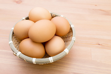 Image showing Brown egg in basket