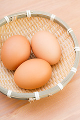 Image showing Brown egg in basket