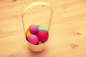 Image showing Colourful painted easter egg in busket