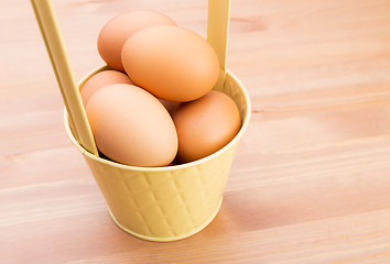 Image showing Brown egg in bucket