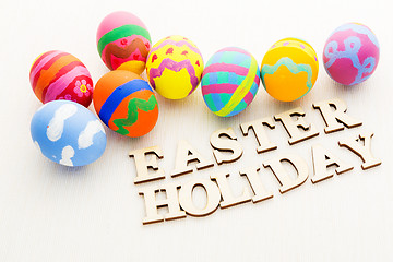 Image showing Colourful pattern easter egg with wooden text