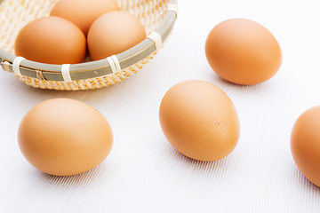 Image showing Fresh brown and white eggs on white cloth