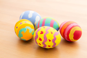 Image showing Painted easter egg on wooden table