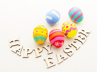 Image showing Painted easter egg with wooden text on linen background