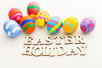 Image showing Colourful easter egg with wooden text 