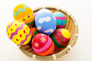 Image showing Colourful easter egg in wicker basket