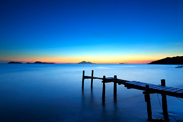 Image showing Wooden jetty with seascape during sunet