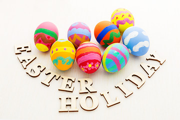 Image showing Painted easter egg with wooden letter