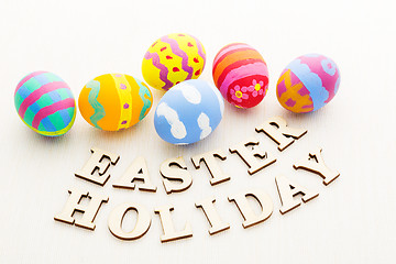 Image showing Painted easter egg with wooden text 