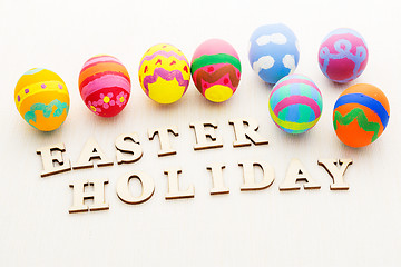 Image showing Painted easter egg with wooden text