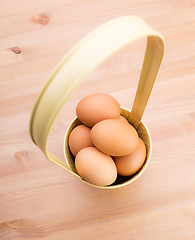 Image showing Brown egg in bucket