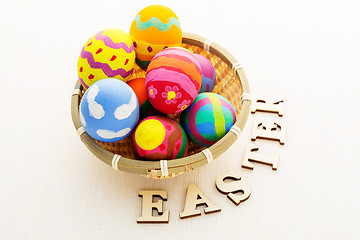 Image showing Easter egg in basket with wooden text