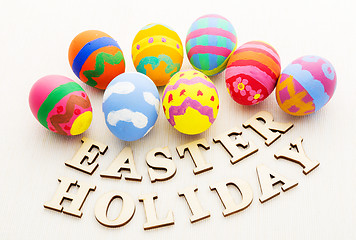 Image showing Children painted easter egg with wooden text