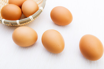 Image showing Fresh brown and white eggs on white cloth