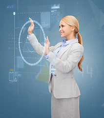 Image showing smiling businesswoman working with virtual screen