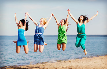 Image showing girls jumping on the beach