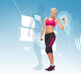 Image showing young sporty woman with light dumbbells