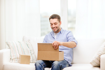Image showing man with cardboard boxes at home