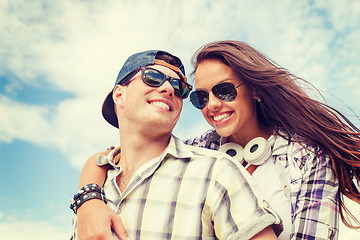 Image showing smiling teenagers in sunglasses having fun outside