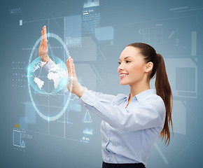 Image showing smiling businesswoman working with virtual screen