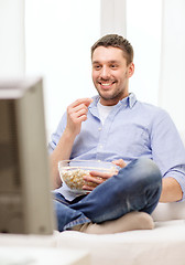 Image showing smiling man watching sports at home