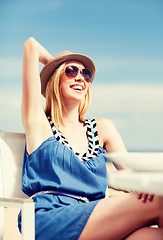 Image showing girl in shades in cafe on the beach