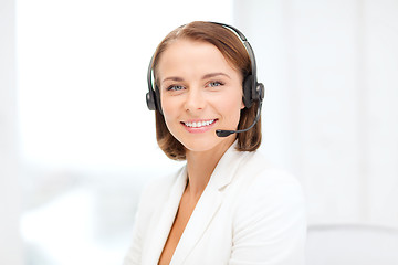 Image showing smiling female helpline operator with headphones