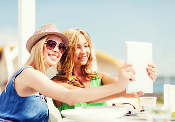 Image showing girls taking photo in cafe on the beach