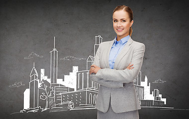 Image showing young smiling businesswoman with crossed arms