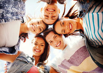 Image showing group of teenagers looking down