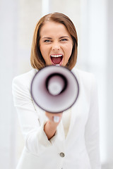 Image showing strict businesswoman shouting in megaphone