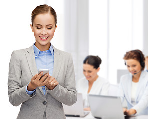 Image showing young smiling businesswoman with smartphone