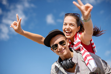 Image showing smiling teenagers in sunglasses having fun outside