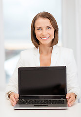 Image showing smiling businesswoman with laptop computer