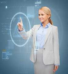 Image showing smiling businesswoman working with virtual screen