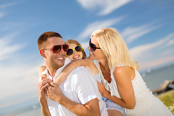 Image showing happy family in sunglasses having fun outdoors