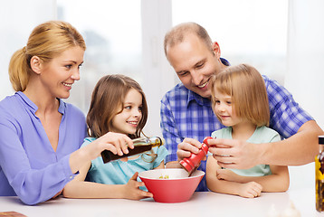 Image showing happy family with two kids making dinner at home