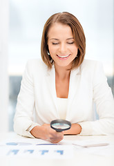 Image showing businesswoman or student in working with graphs