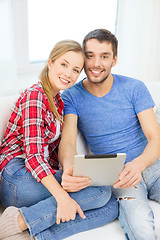 Image showing smiling happy couple with tablet pc at home